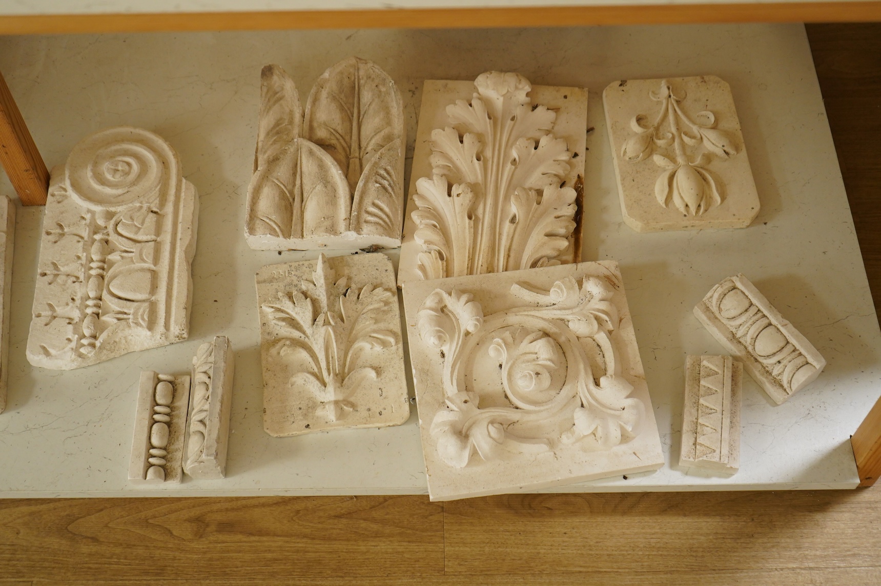 A collection of plaster-cast relief panels to include classical busts and foliage, largest 47cm high